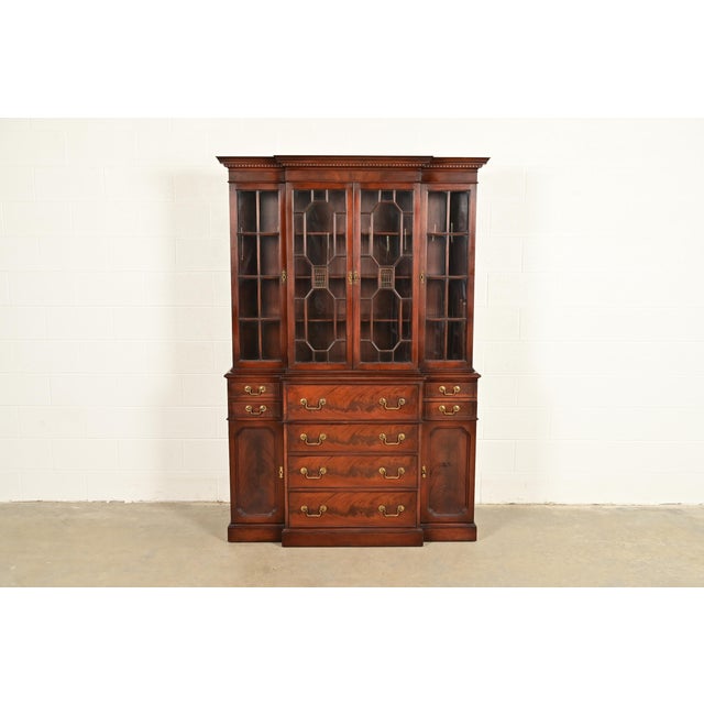A gorgeous Georgian or Chippendale style breakfront bookcase or dining cabinet with drop front secretary desk In the...