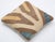 A one-of-a-kind handwoven Afghan wool kilim accent pillow featuring oversized zigzag chevrons in brown and cream with blue...