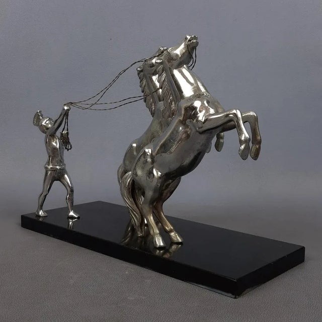 Stunning vintage collectible sculpture, depicting a Roman trainer with 2 horses. Work made of chromed metal on a black...