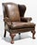 Classic Ethan Allen leather wingback armchair featuring a tall, sculptural back, rolled arms with decorative nailhead...