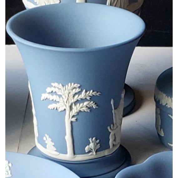 This delightful vintage 1975 matte pale blue Jasperware small, flared bud vase showcases the delicate neoclassical...