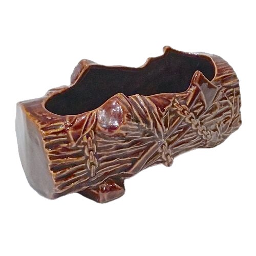 Vintage faux-bois log cachepot with footed base and logging tool accents. No makers marks.