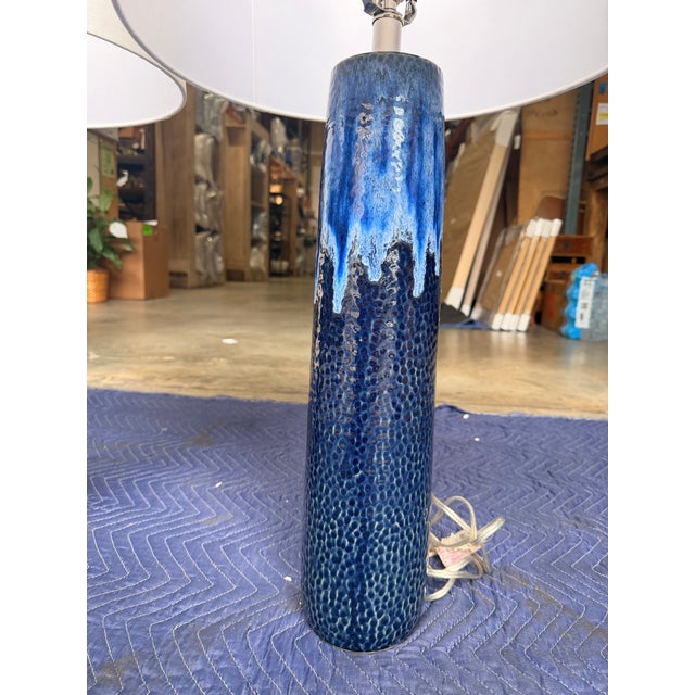 This stylish table lamp blends boho charm with contemporary design, featuring a sleek blue ceramic base in a deep cobalt...