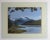 Oil on artist board painting of mountain lake. Unsigned. Displayed firmly attached to mat and backing, fading to mat.