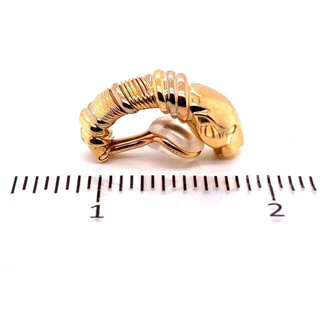 The Cartier Panthere 18k Tri-Color Gold Clip On Huggie Earrings are a luxurious and stylish piece of vintage jewelry from...