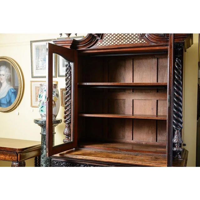 C.1860, Italian cabinet with exuberant details. The top portion has three shelves in the interior while the outside has...
