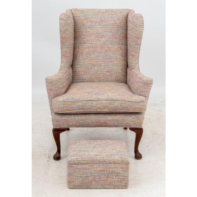 Modern Wingback Arm Chair and Foot Stool, 20th century, with multicolored cotton upholstery. 34.5" H x 33.25" W x 28" D;...