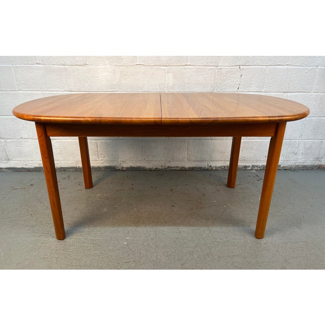 Beautifully crafted Mid-Century Modern teak oval extension dining table, a timeless piece that combines sophisticated...