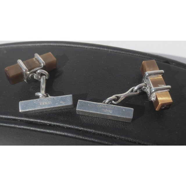 Classic bar cufflink. Cats Eye stone with sterling mounts. The measurements are .75" by 1.25" wide, vintage 1950s