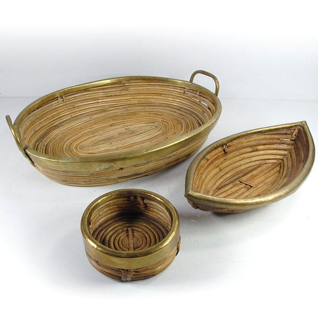 A highly decorative set of rattan bowls/containers. All items are finished with a gold-colored metal trim. They date from...