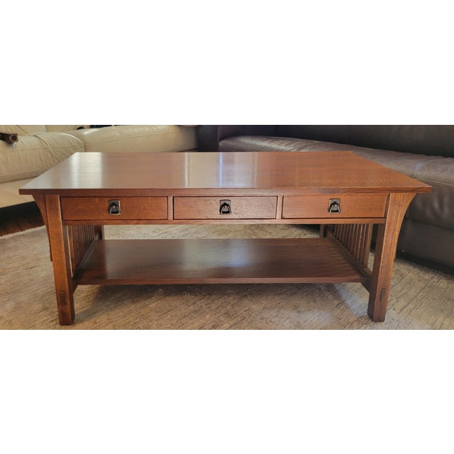 Gorgeous mission style cocktail/coffee table by master furniture maker Stickley. Three drawers with signature mission...