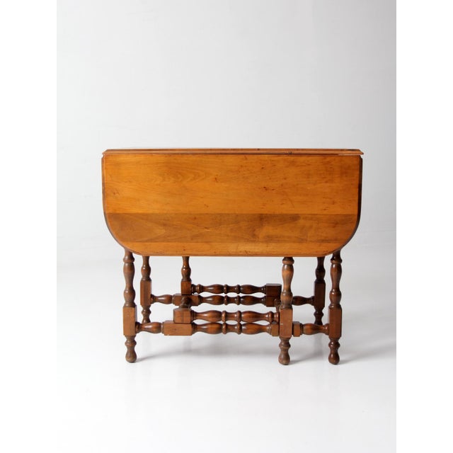 A classic Early American gateleg table with a warm, inviting presence and balanced proportions. The drop-leaf design opens...