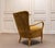 The chair features an elegant and highly sculptural form, with gracefully curved elm armrests and legs that flow...