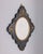 Wall mirror with black wooden frame and gilded bronze decorations, Italian design, early 20th century.