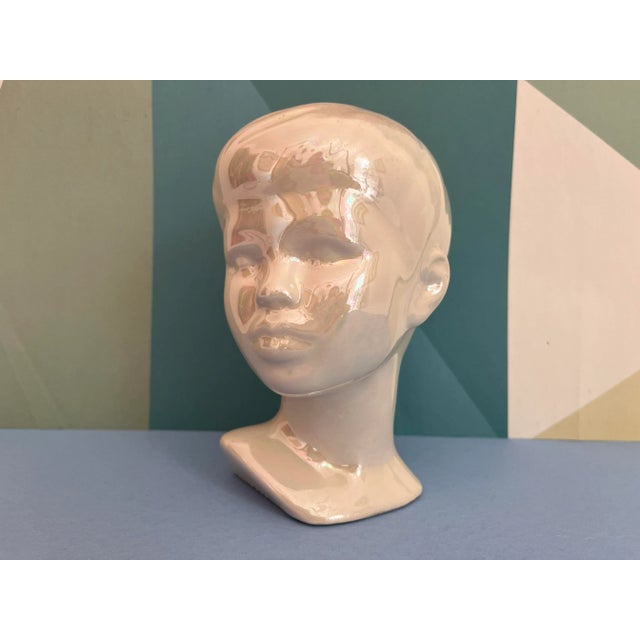 Demure and darling hand crafted bust of a young boy in a glossy opalescent vanilla glaze with lifelike incised details...