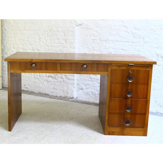 Small Art Deco cubist desk made of light walnut veneer on two sides. It features 2 wide, deep drawers under the tabletop...