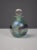 Elegant blown glass perfume bottle by Isle of Wight Studio Glass. The spherical body displays a stunning green and blue...