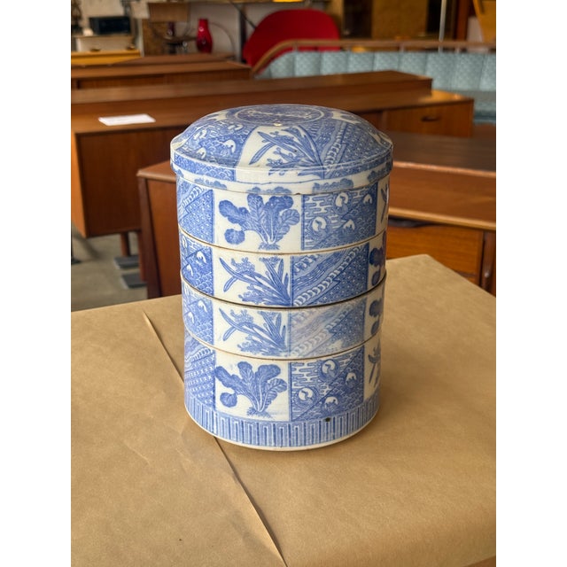 This 5 tier antique set is absolutely superb. Blue and white porcelain. Note that there is some gold "fill" repairs,...