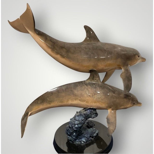 Limited edition bronze sculpture titled “Ocean Travelers” by renowned marine life artist Wyland. Features two dolphins...