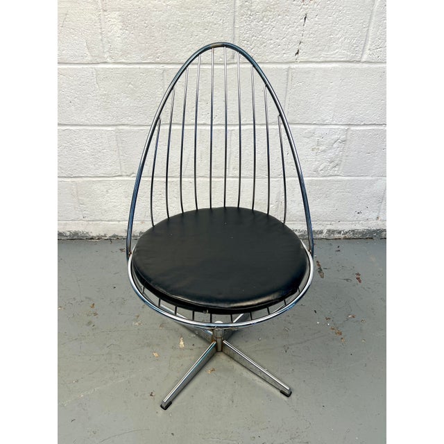 Iconic mid-century modern Swedish swivel egg chair designed by Arne Dahlén. Features a sculptural form set on a polished...