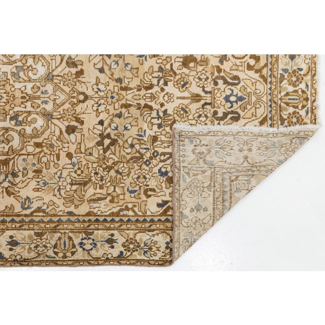 Elevate high-end interior spaces with this authentic vintage hand-knotted wool area rug. Featuring a sophisticated,...