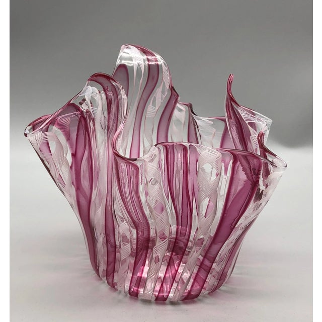 Striking vintage Murano art glass handkerchief vase featuring rich cranberry glass with delicate white latticino...