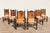 Beautiful vintage set of six Spanish Revival dining chairs featuring dark carved wood frames paired with warm tan leather...