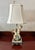 Vintage Porcelain Cherub Table Lamp. A porcelain figural table lamp featuring cherubs or putti figures, similar in style...