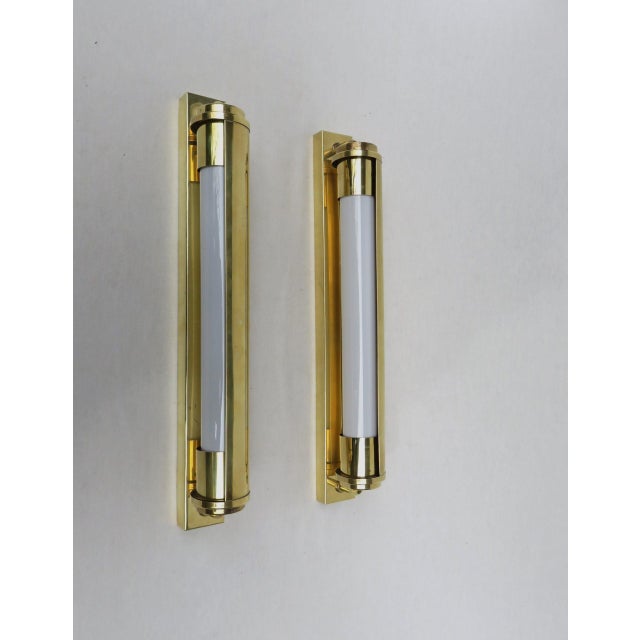 A pair of minimalist wall lights, festoon lamps, with shades from the Bauhaus era, made in Germany. They can be mounted...