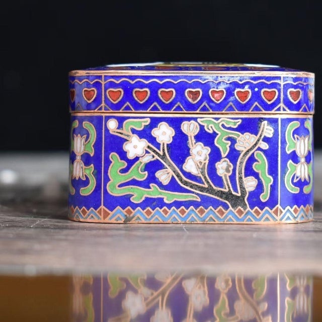 This unique and charming rectangular lidded box is crafted in the traditional cloisonné enamel technique on a copper base....
