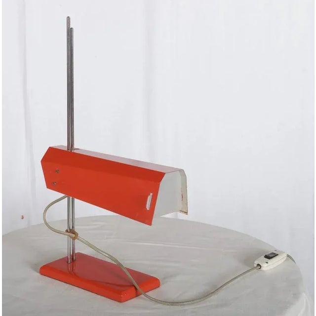 Orange table lamp produced in the 1970s. Made from chromed and red lacquered steel. European Plug (up to 250V).The wiring...