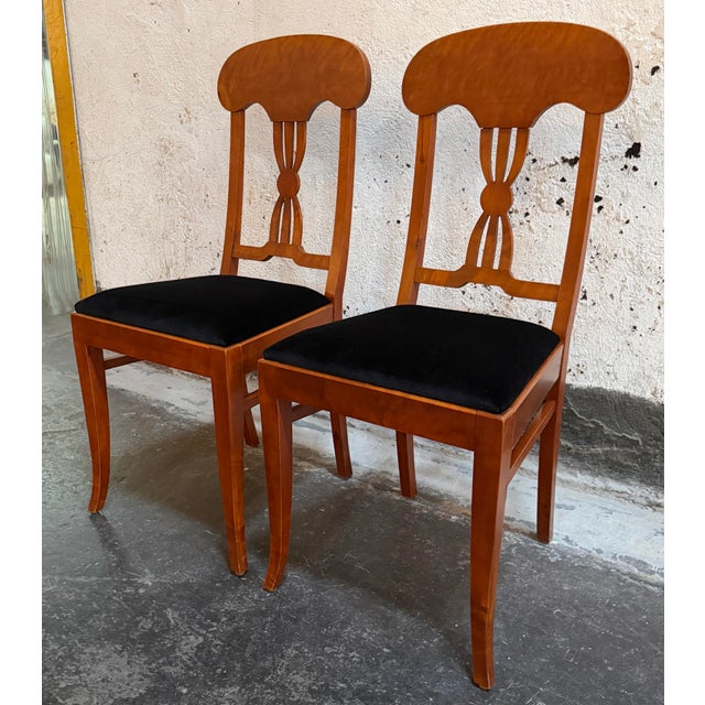 Exquisitely graceful pair of antique Karl Johan Revival dining chairs, embodying the timeless elegance of the early 20th-...