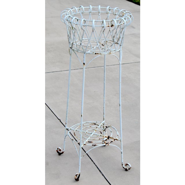 Add timeless French country charm to your home or garden with this beautiful vintage wrought iron jardinière plant stand....