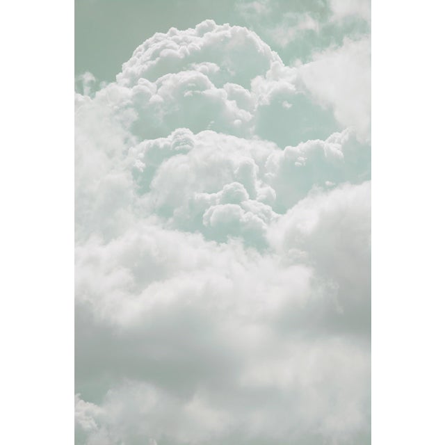This photograph captures a serene expanse of clouds, rendered in soft, muted tones that evoke a sense of tranquility. The...