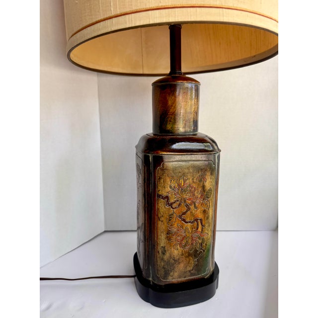 A classic Frederick Cooper Chicago table lamp in the form of an antique tea canister, c. 1960s–70s. All four sides feature...