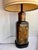 A classic Frederick Cooper Chicago table lamp in the form of an antique tea canister, c. 1960s–70s. All four sides feature...