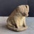 A handsome English garden stone pig or hog, modeled on its haunches, on raised oval base. A fine ornamental garden feature...