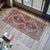 This exquisite hand-knotted mat from the Denizli region features vibrant earthy tones and traditional geometric medallions...
