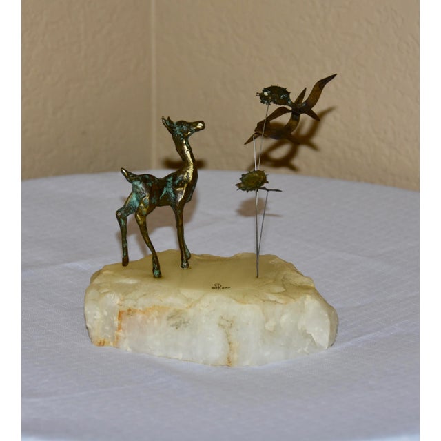 Brutalist bronze sculpture depicting a deer amidst flying seagulls leaves on wire stems. Mounted on a white onyx plinth....