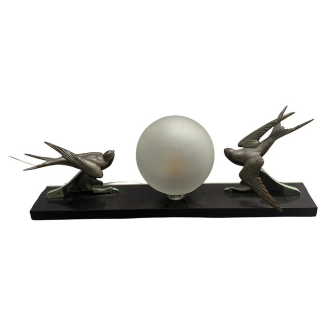 This 1930s Italian Art Deco table lamp features a polished black marble plinth serving as the base for two stylized...
