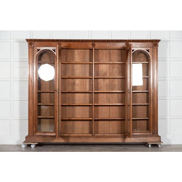 Circa 1870. Monumental 19th century English pine arched glazed bookcase. Measures: W 267 x D 35 x H 203 cm.