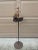 An exceptionally sculptural vintage wrought iron floor ashtray fashioned as a stylized sailing ship, dating to the 1920s....
