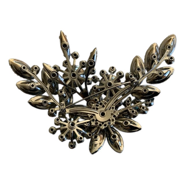 From the research I have done this seems to be.... "Vintage aura borealis blue and rhinestone floral brooch".