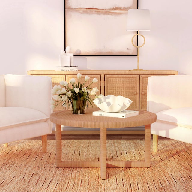 The Captiva round coffee table offers organic beauty and coastal elegance featuring a handwoven rattan top and sturdy...
