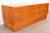 This low-profile Danish cabinet by Hundevad features warm teak construction, four dovetailed drawers, and recessed pulls....