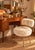 A glamorous dressing chair from the 1960s-1970s, featuring a circular seat and a rectangular back with rounded corners,...