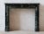 This refined antique marble fireplace is crafted from deep green marble that appears almost black, featuring delicate...
