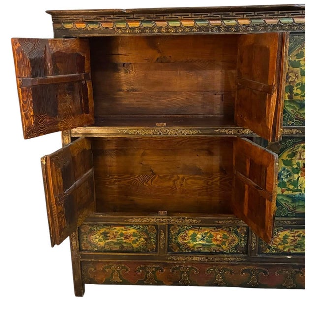 A Beautiful Tall Antique Cabinet featuring hand-painted floral designs across its panels with amazing color's and patina....