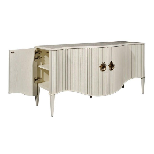 Swedish inspired cabinet is wrapped in tambour, concealing two wide curved doors and 2 disguised side wrapping doors....