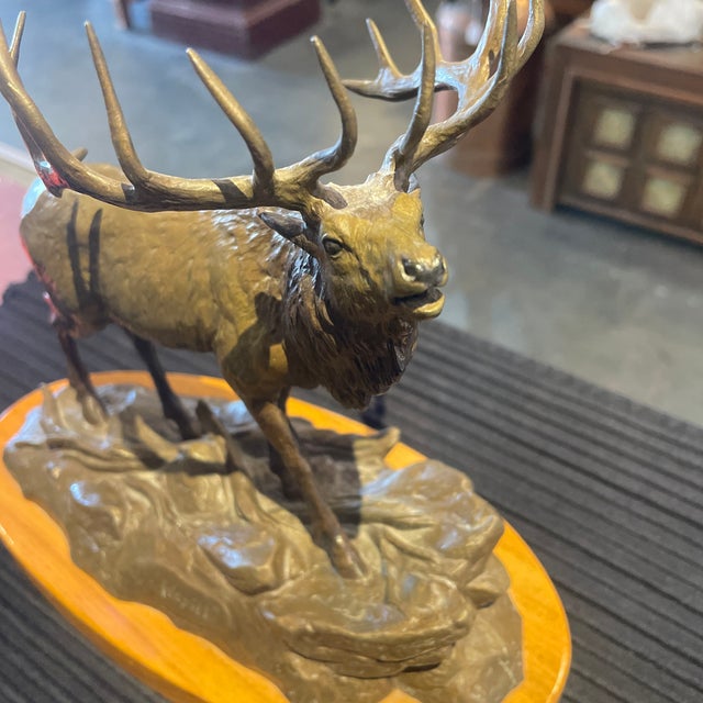 Original bronze by Clark Bronson entitled “Wapiti” 1980 Elk on wood stand , measuring 9 tall 6 Wide 10 long on base. Such...